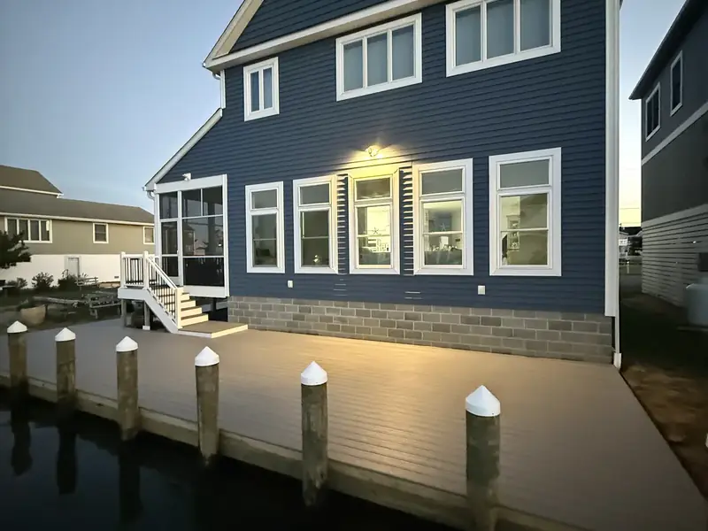 Completed blue waterfront home and deck