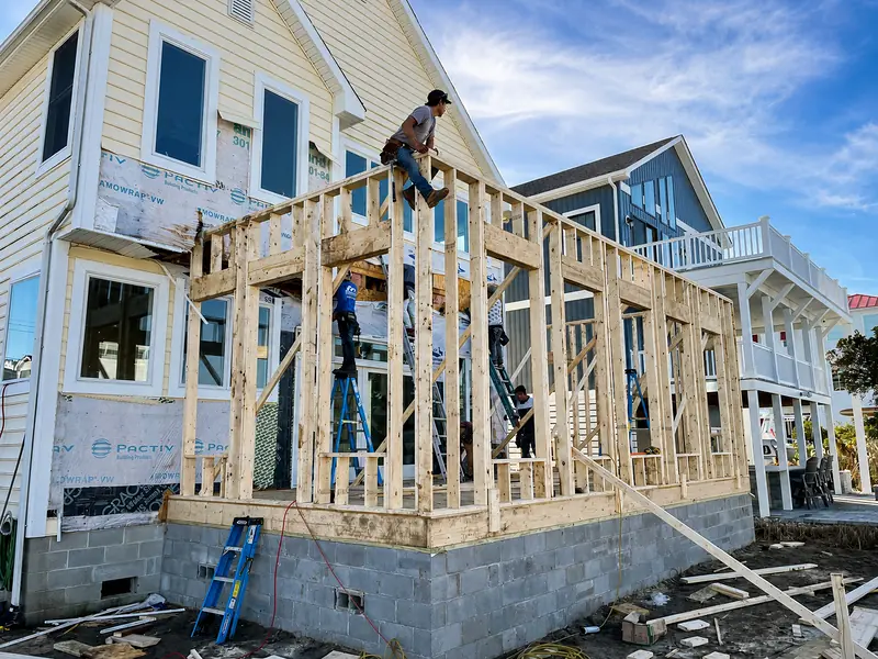Crew framing a waterfront home addition