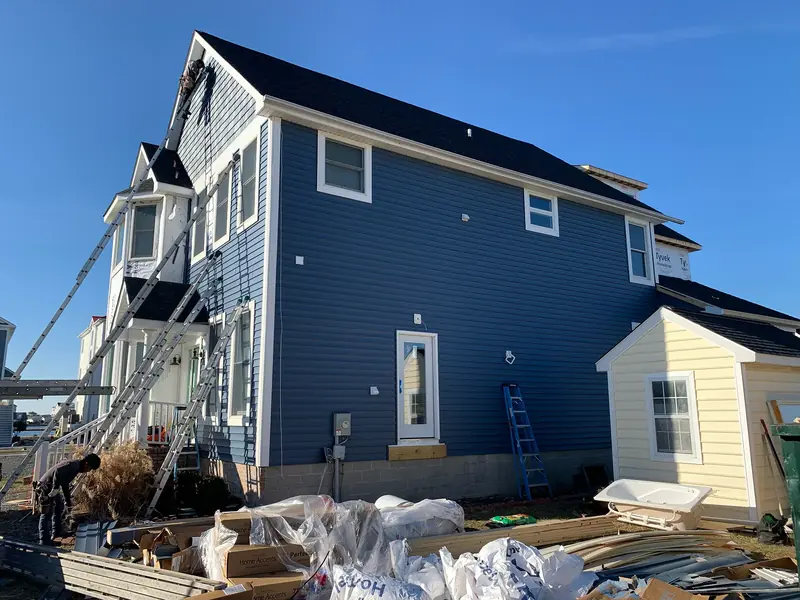 Blue siding installation during a waterfront renovation